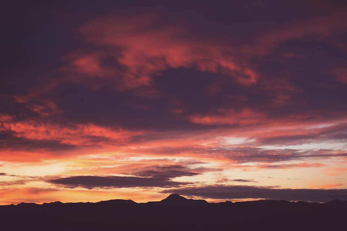 sunrise silhouette photo of mountain during golden hour sunset