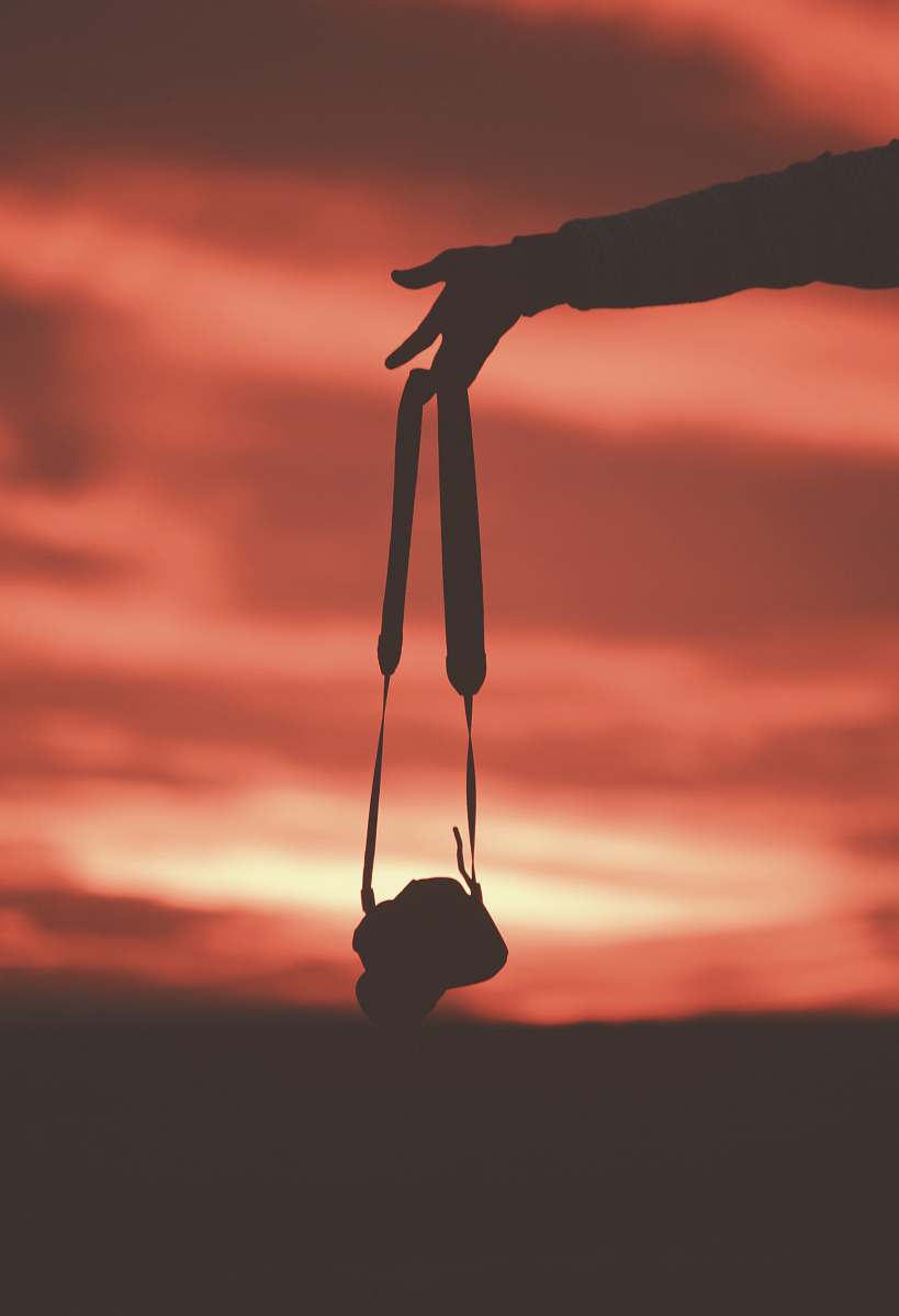 sunset silhouette photography of person holding DSLR camera nature