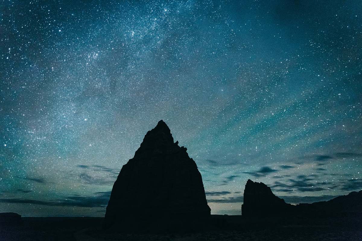night silhouette of rocky mountain under starry sky universe