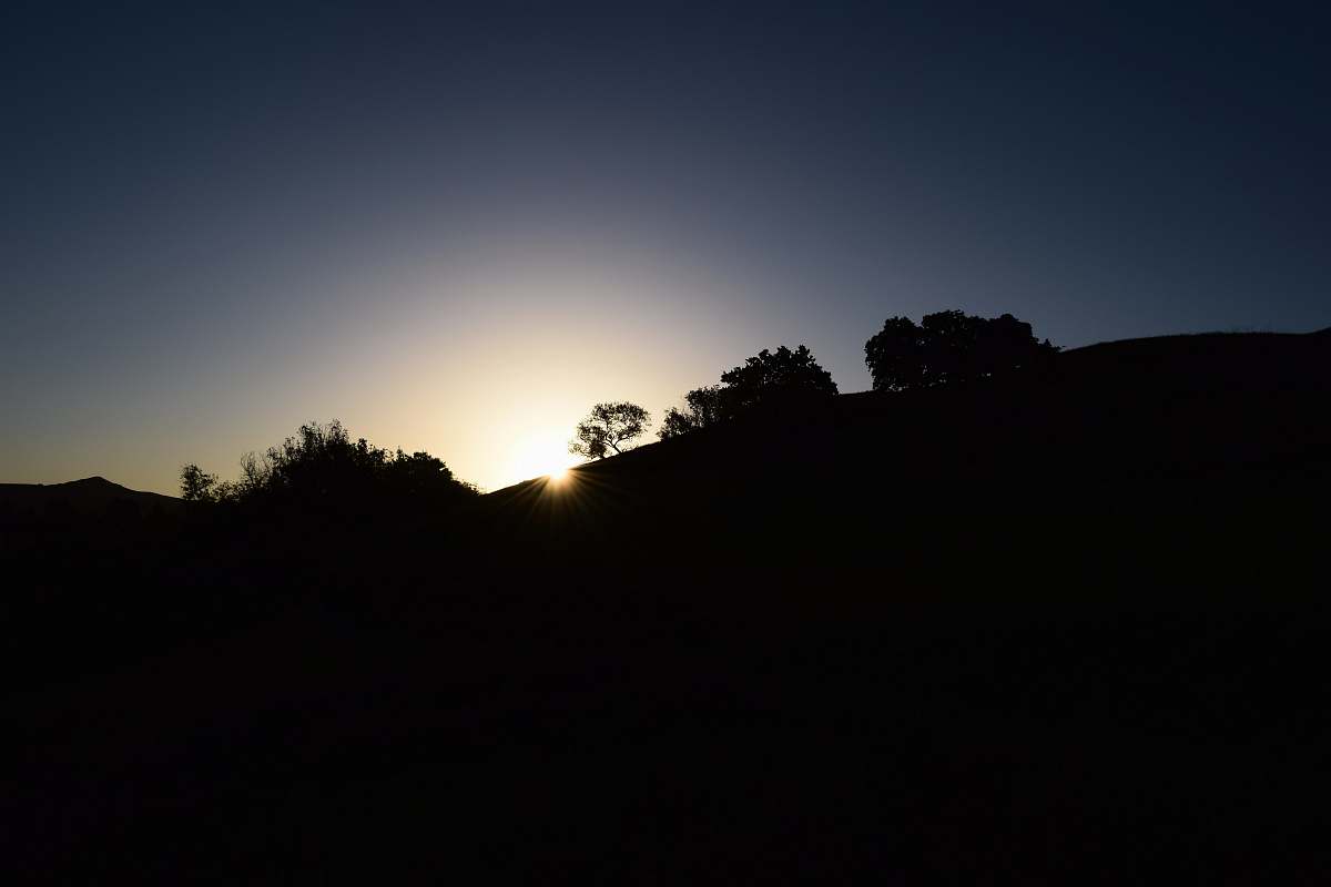 sunset silhouette photo of mountain nature