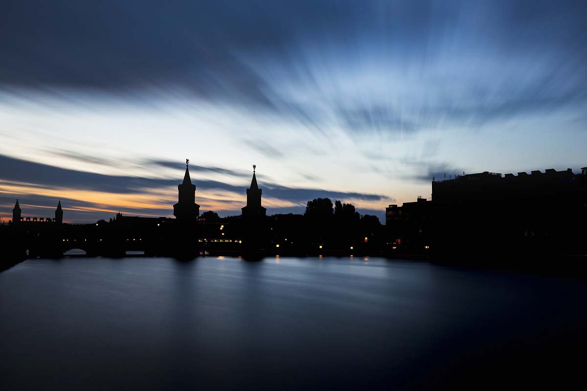 dusk body of water near concrete buildings architecture