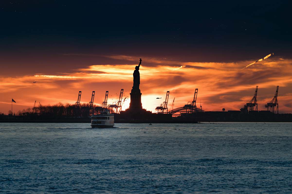 sunrise silhouette of Statue of Liberty near body of water river
