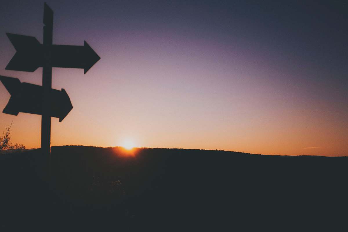 sunrise silhouette of two arrows sky
