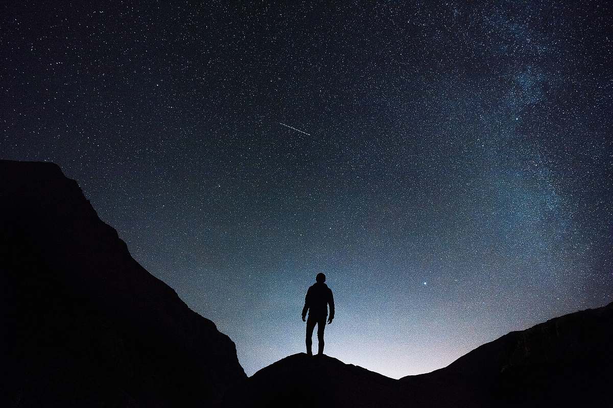 night silhouette of man standing on hill during starry night desktop wallpapers