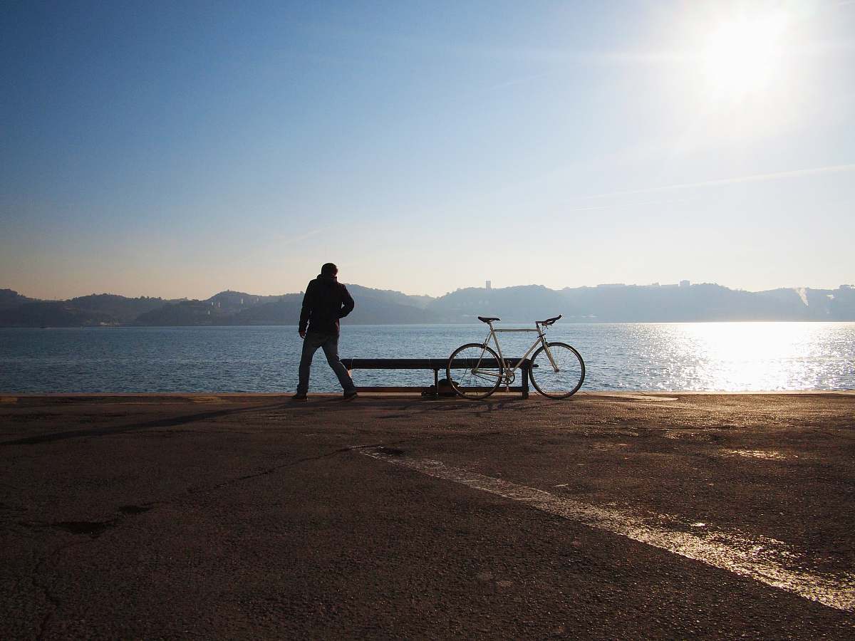 sea person standing beside of city bicycle man