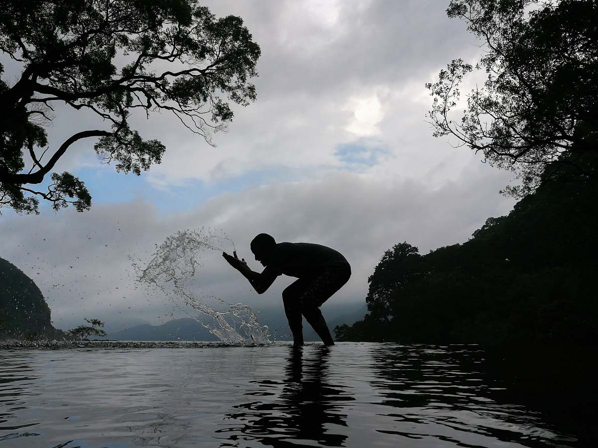 human silhouette of person splashing water person