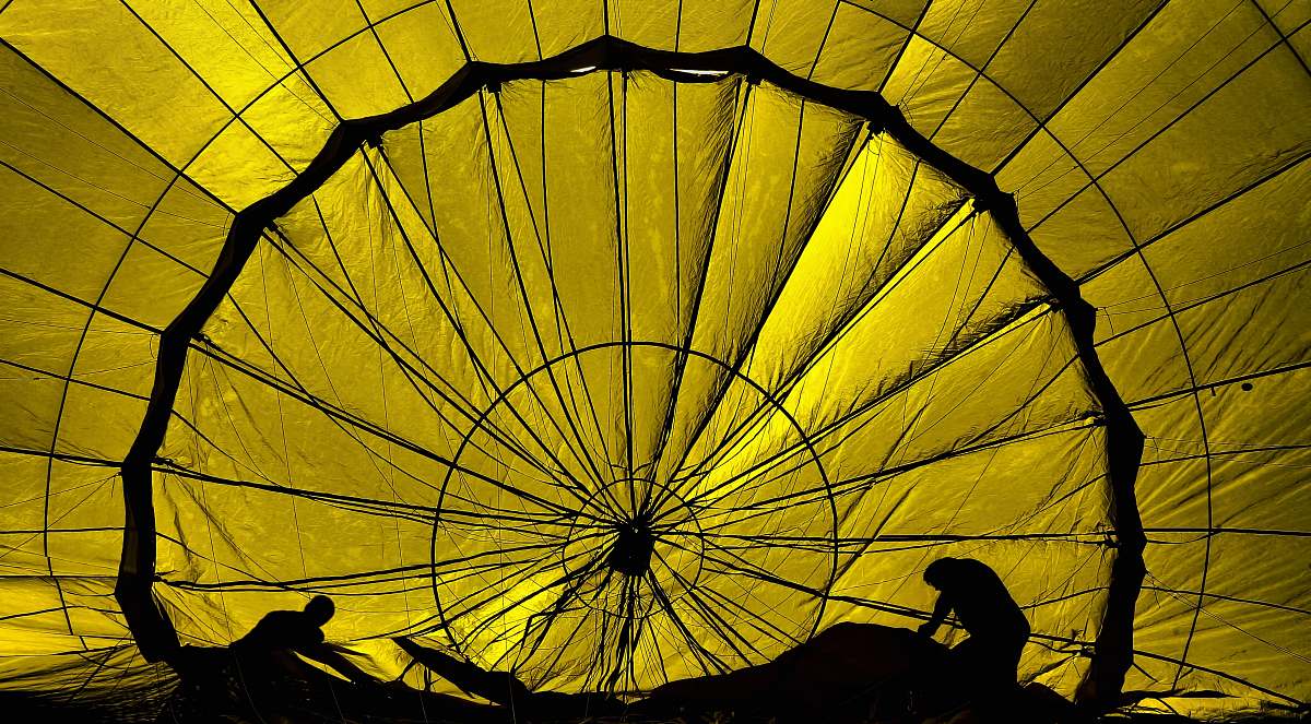 parachute silhouette of two persons working silhouette