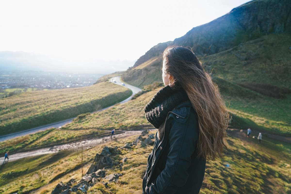  woman standing on hill 