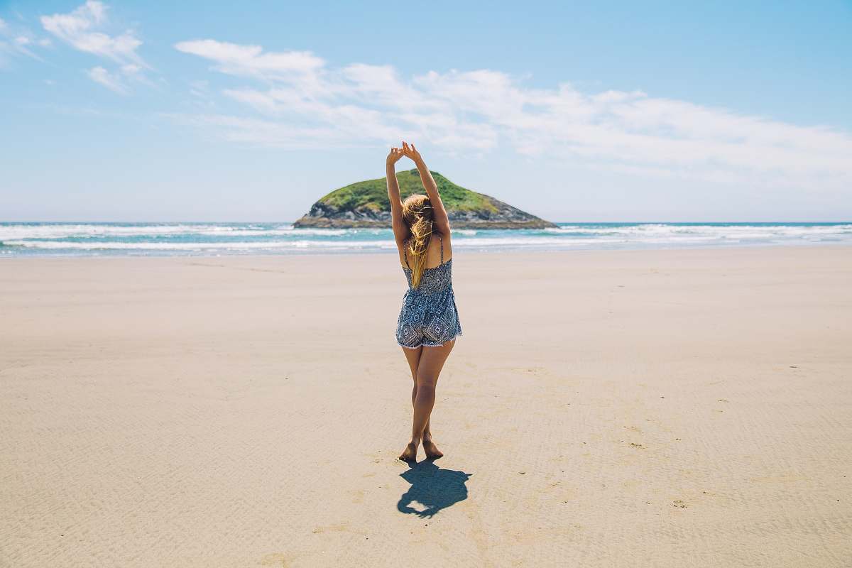 ocean woman on seashore near island under blue sky sea