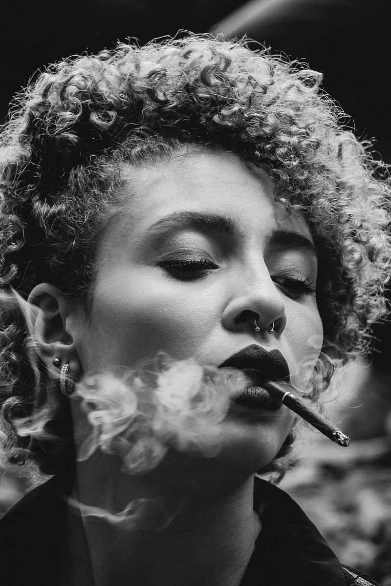 people grayscale photo of woman smoking human
