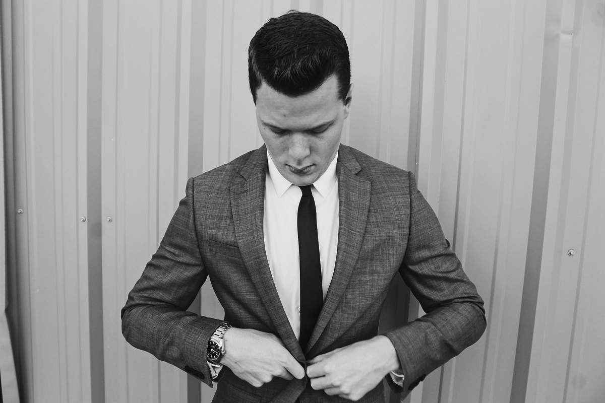 human grayscale photograph of man wearing suit suit