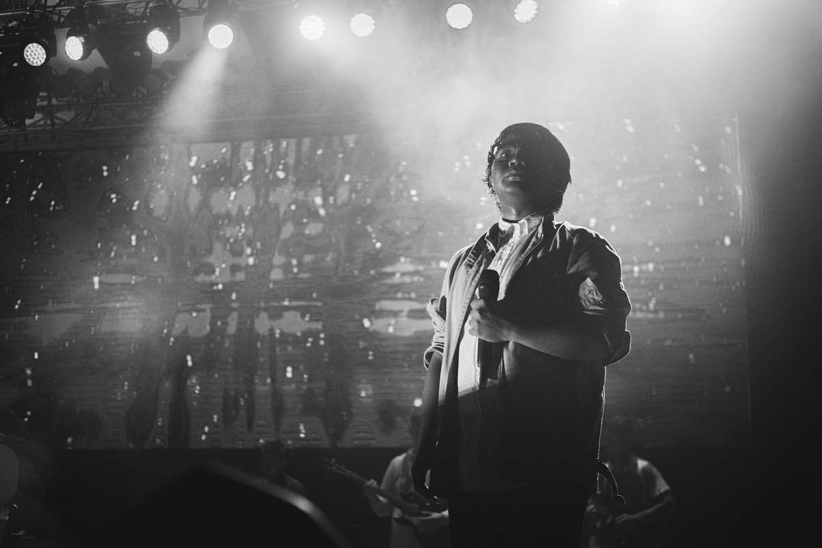 human grayscale photography of singer grey