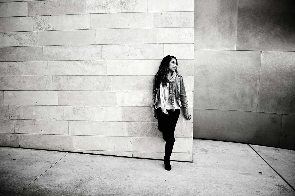 human grayscale photography of woman leaning on wall people