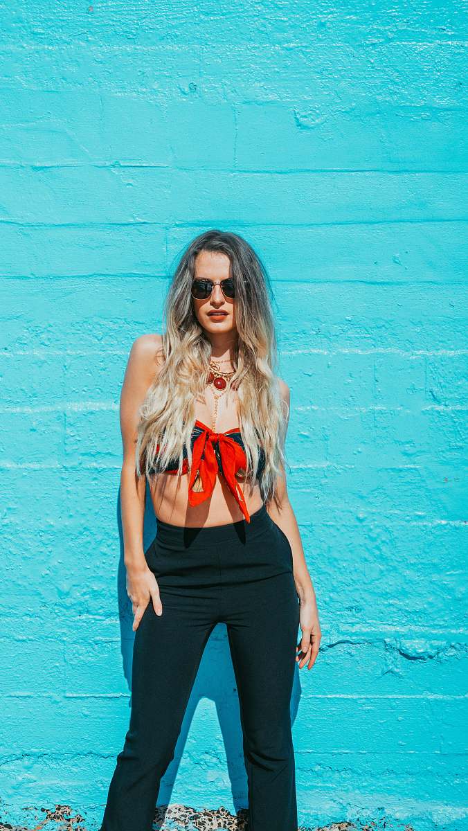 woman woman standing by the blue wall girl