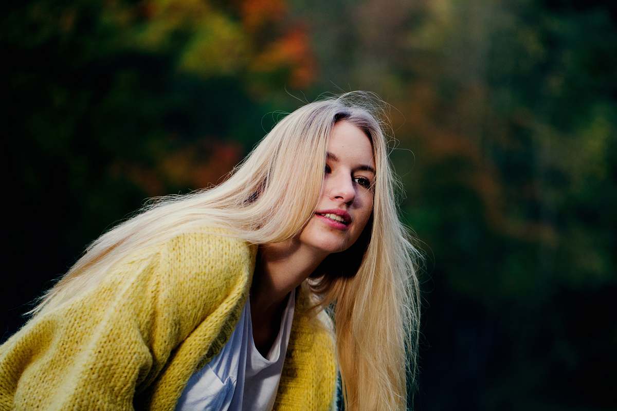 blonde woman wearing yellow cardigan woman
