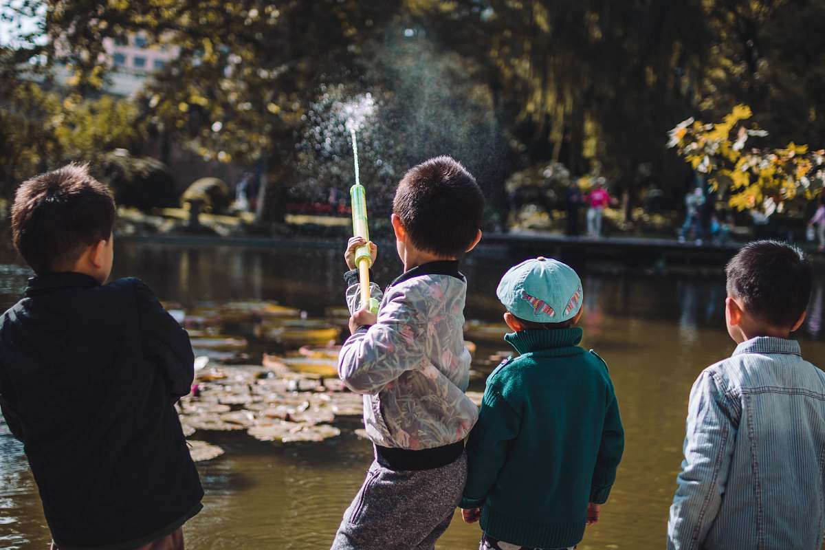 people boy playing near the river person