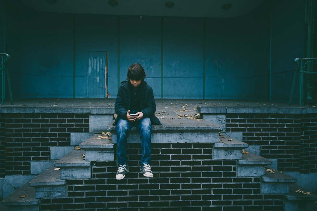 people boy sitting on concrete stairs person