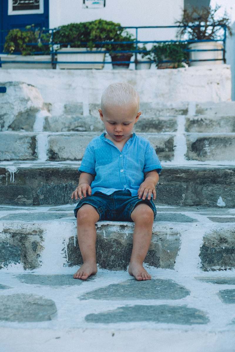 person boy sitting on gray concrete stair people
