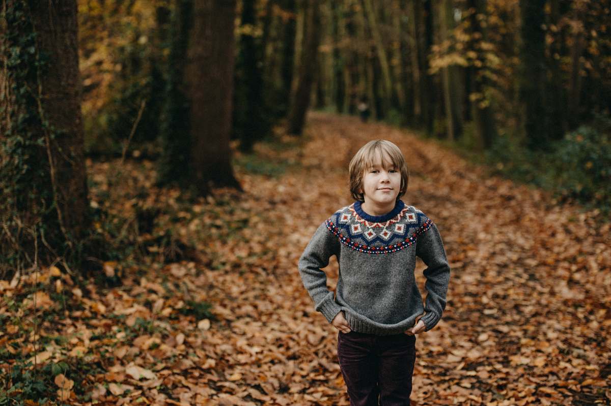 people boy standing between tall trees person