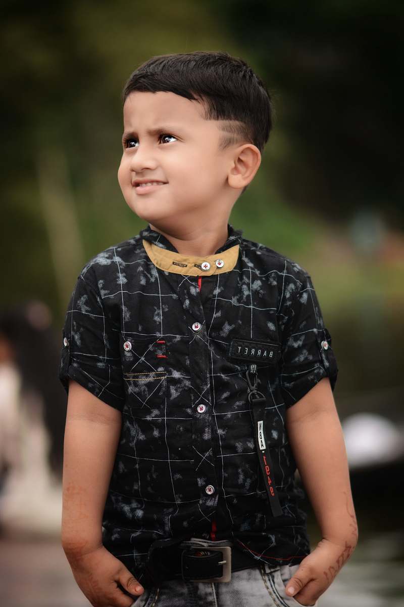 people boy standing holding his pocket during daytime person
