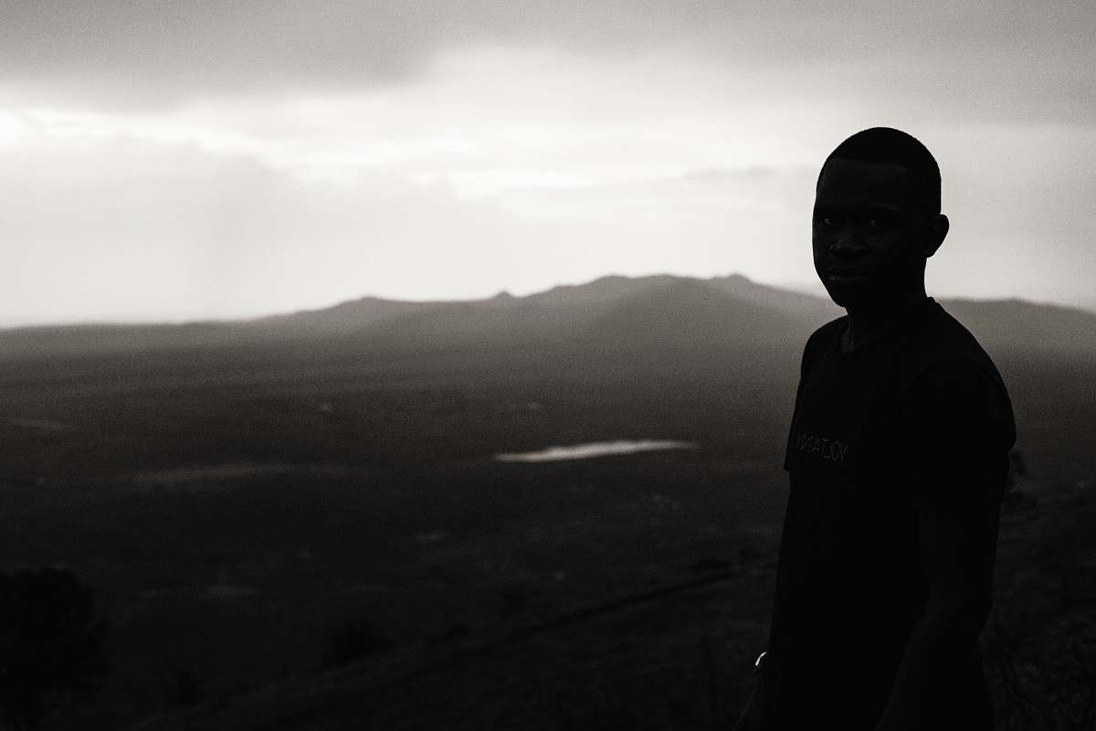 people boy standing on bare hill during foggy day person