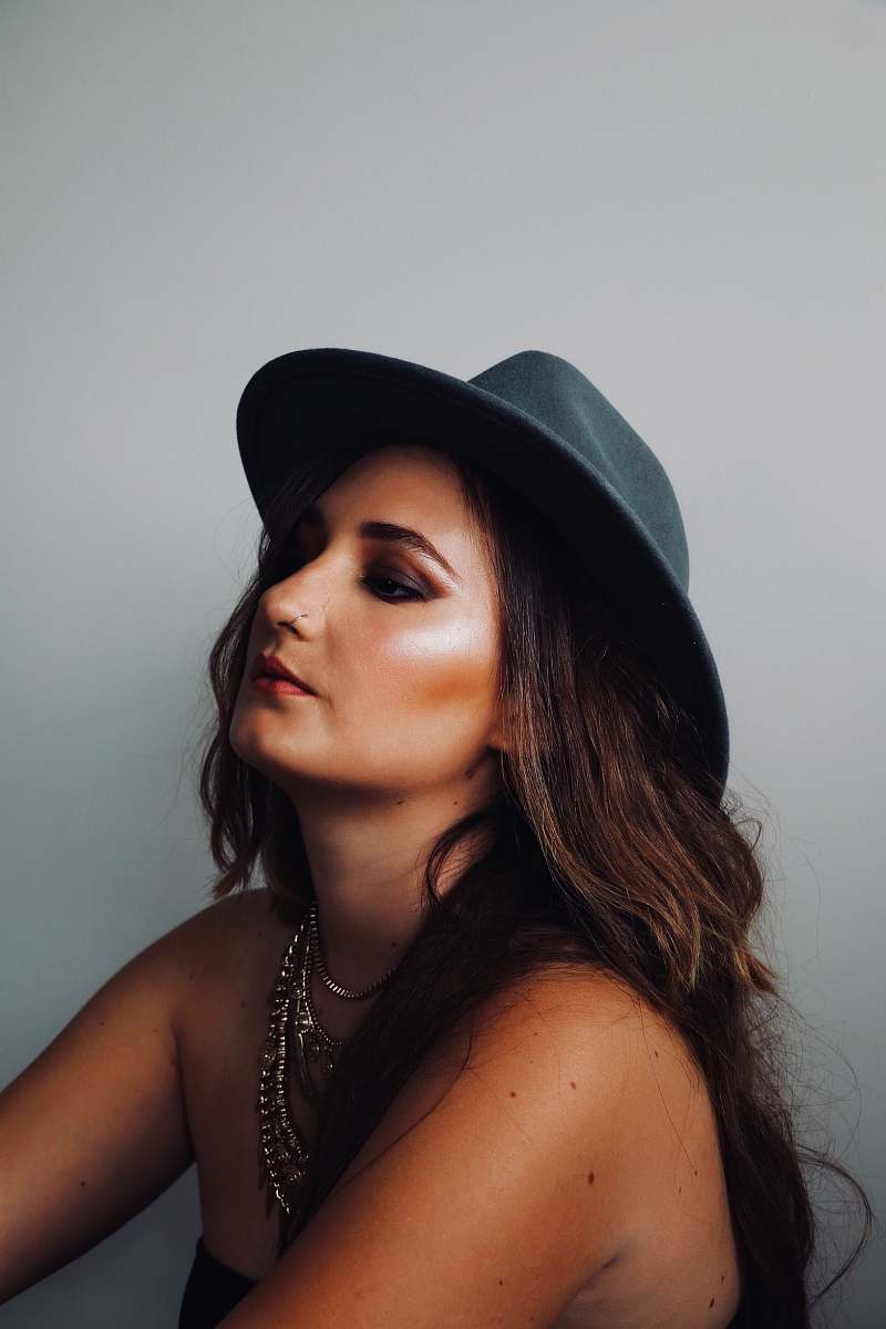 person brown haired woman wearing gray hat people