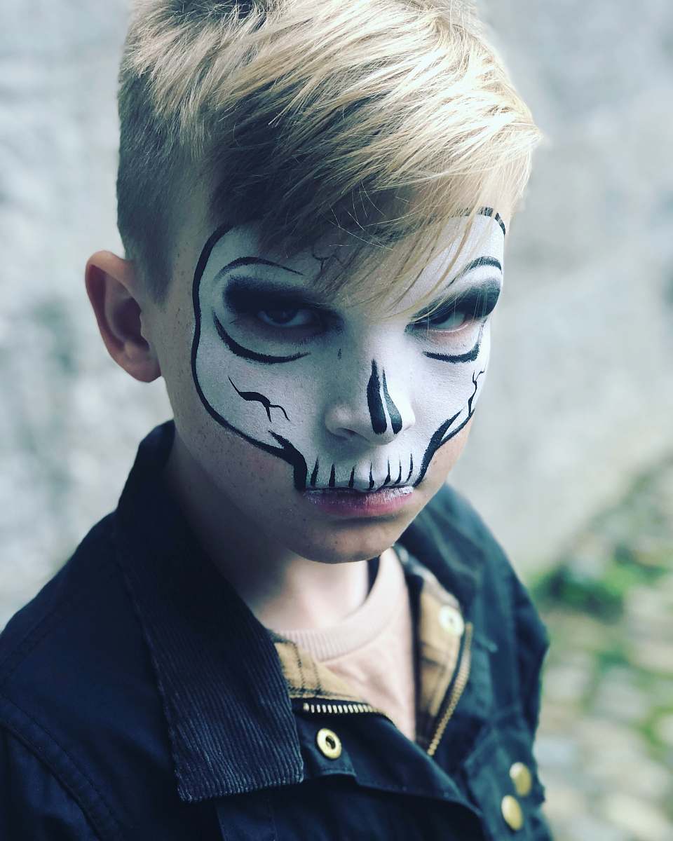 person child with skull face painting people