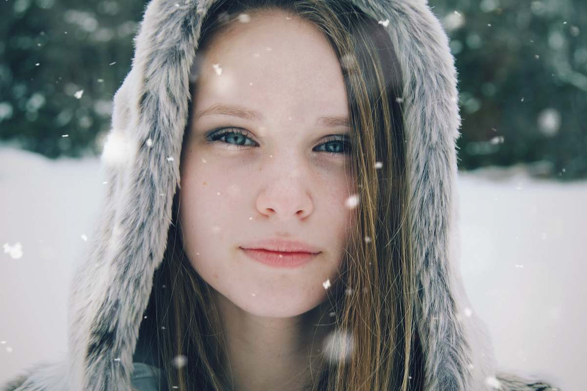 people focus photo of a woman's face wearing parka hoodie person