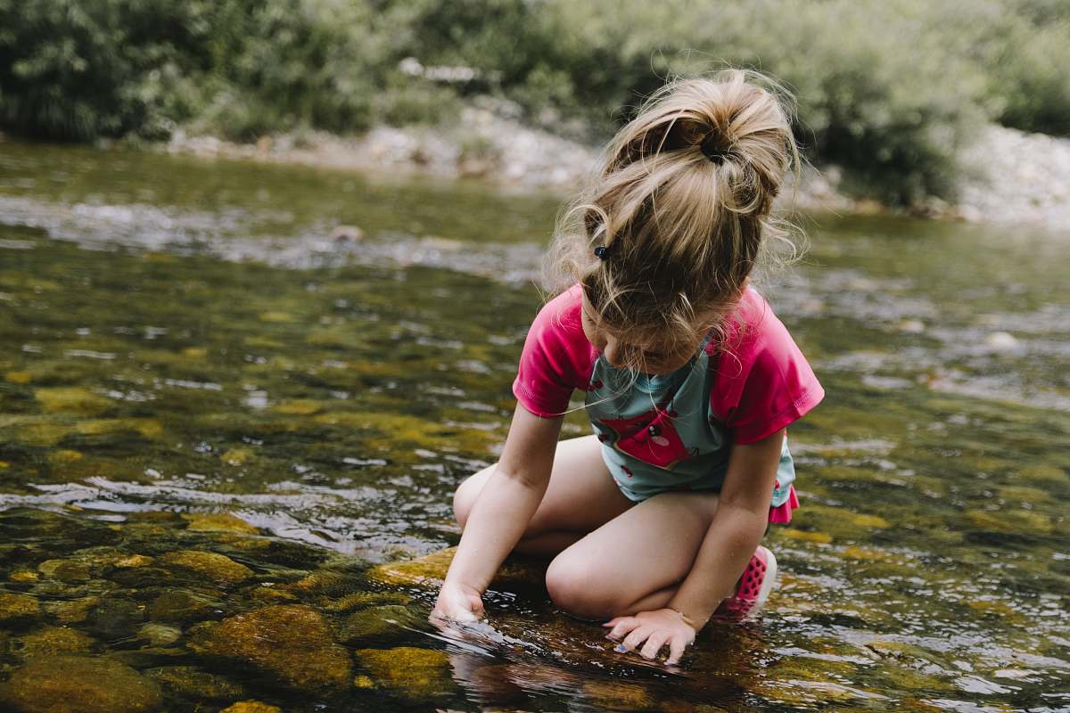 people girl playing on body of water person