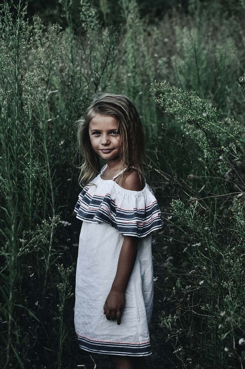 people girl standing near tall grasses person
