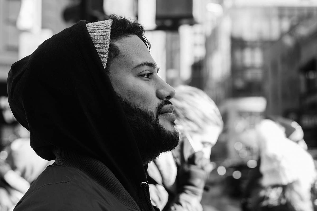 people grayscale photo of man wearing hooded jacket black-and-white