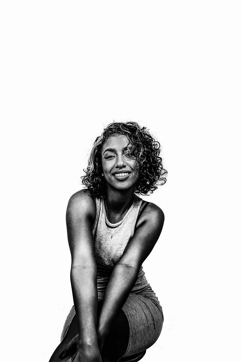 people grayscale photo of woman in tank top black-and-white