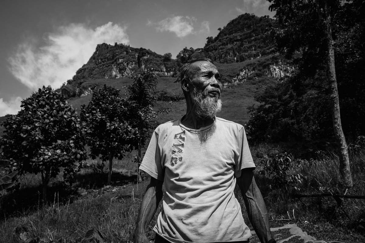 people grayscale photography of man standing near trees black-and-white