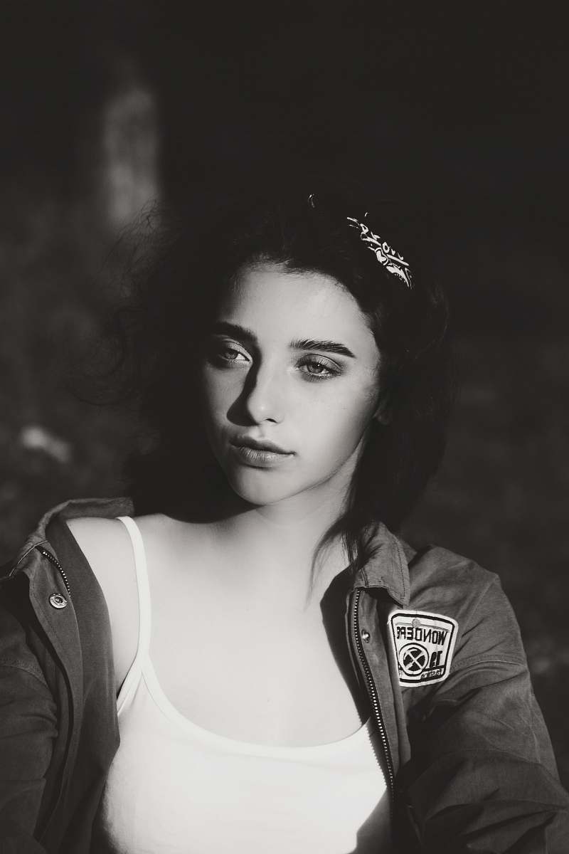 person grayscale photography of woman wearing camisole and jacket black-and-white