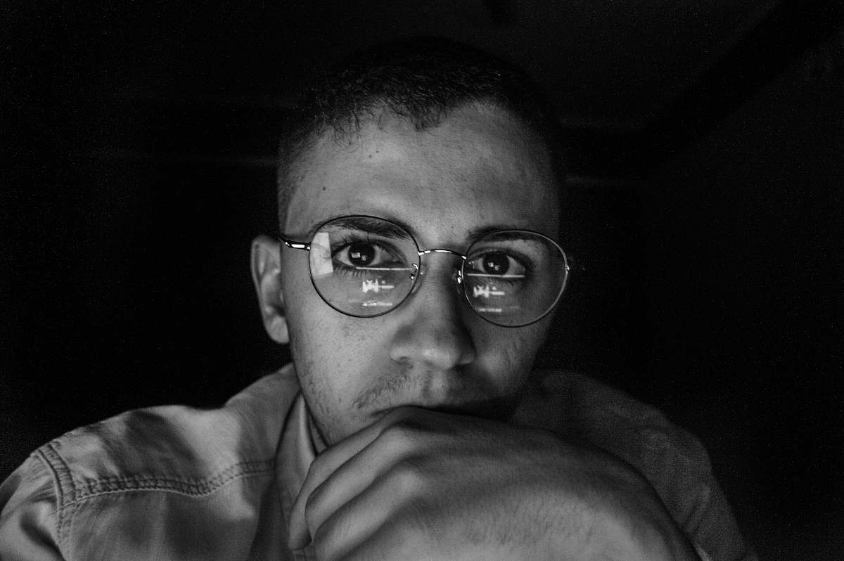 people greyscale photo of man wearing eyeglasses black-and-white