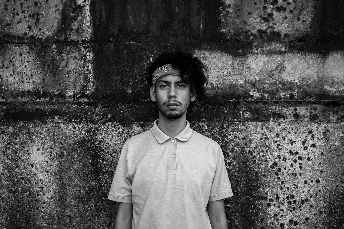 people greyscale photography of man standing black-and-white