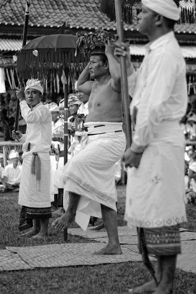 people greyscale photography of men dancing near house black-and-white