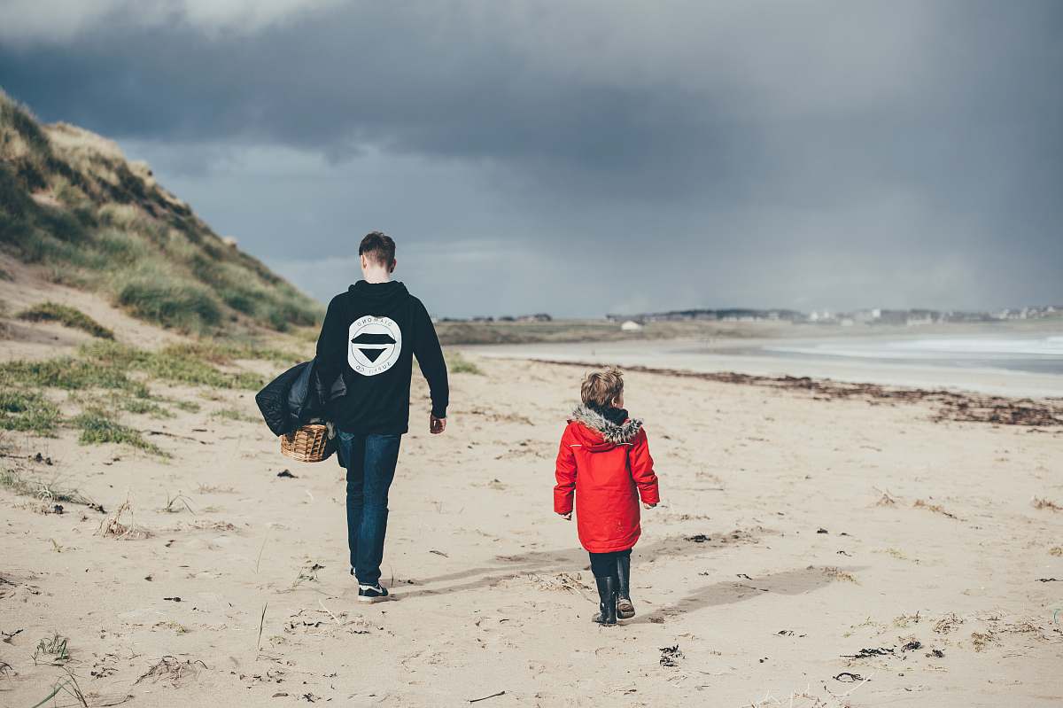 people man and girl walking on beach person