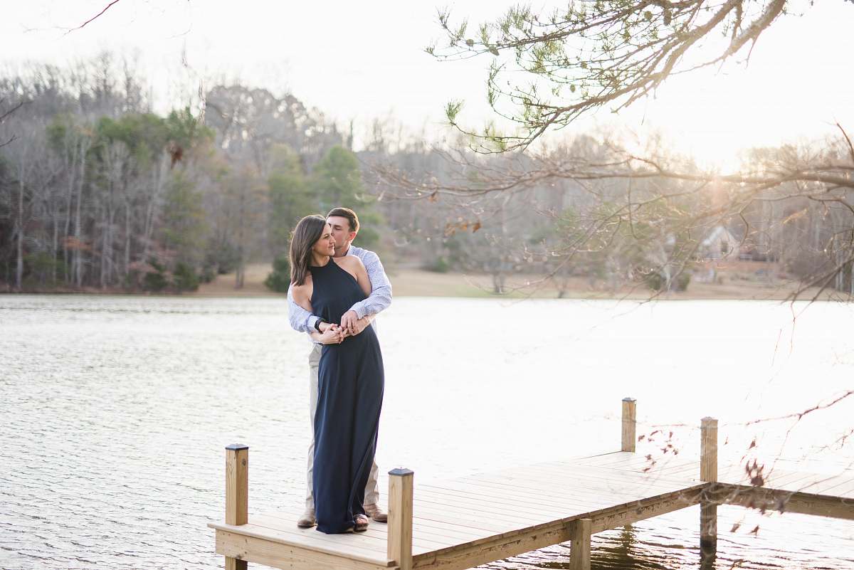 people man and woman hugging on brown wooden dock during daytime person