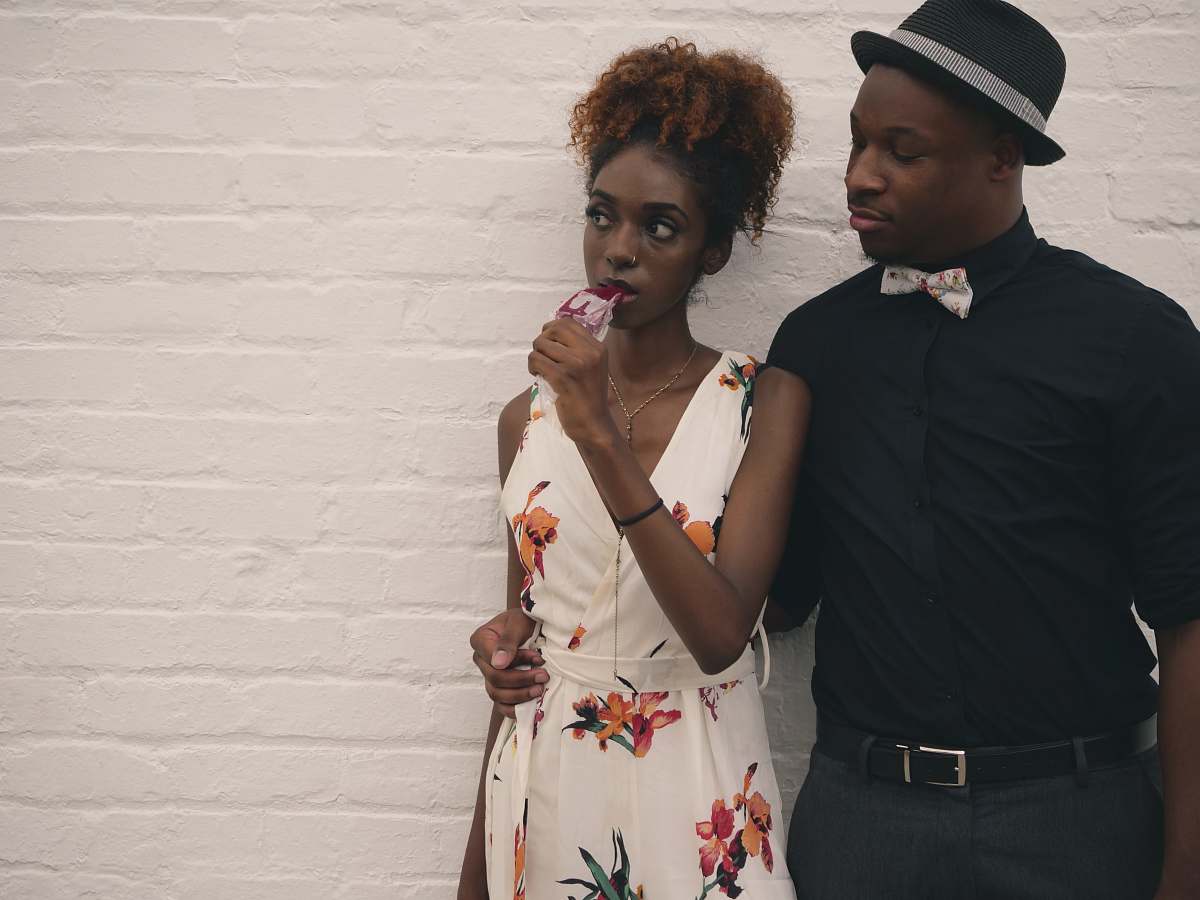 person man and woman standing in front of white painted wall people