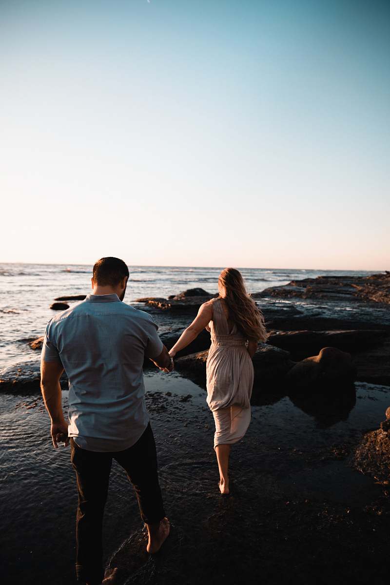 people man and woman walking on seashore person