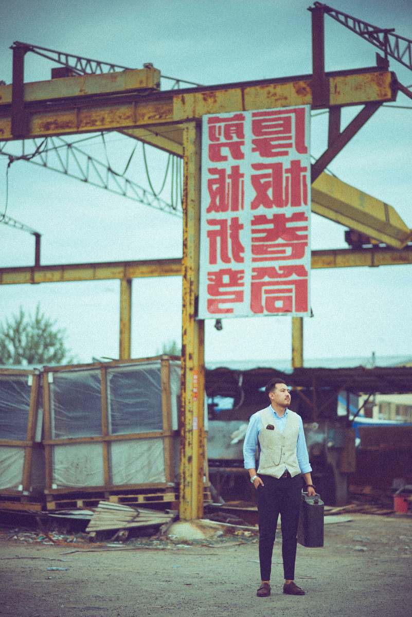 people man carrying case standing near signage board person