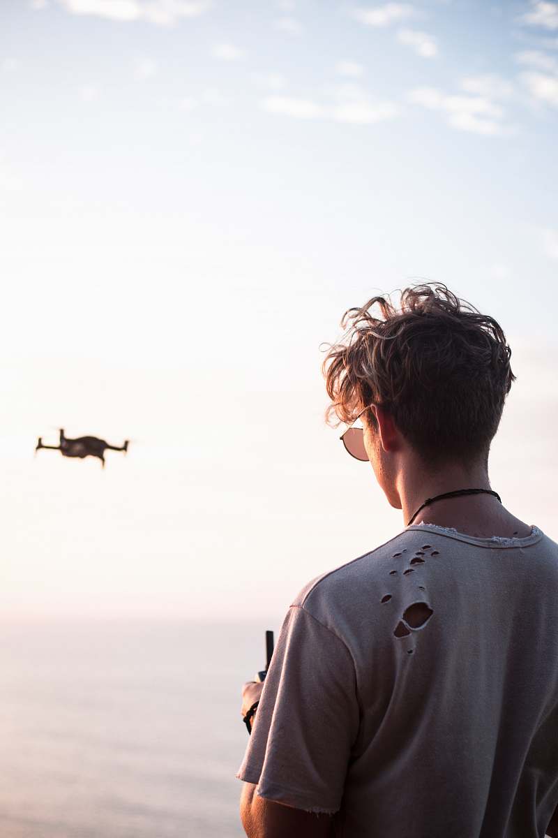 people man controlling drone at daytime person