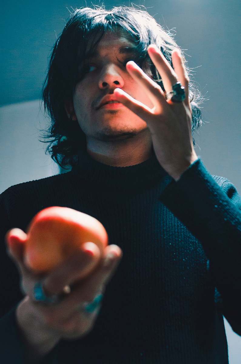 people man holding apple fruit while raising his right hand person