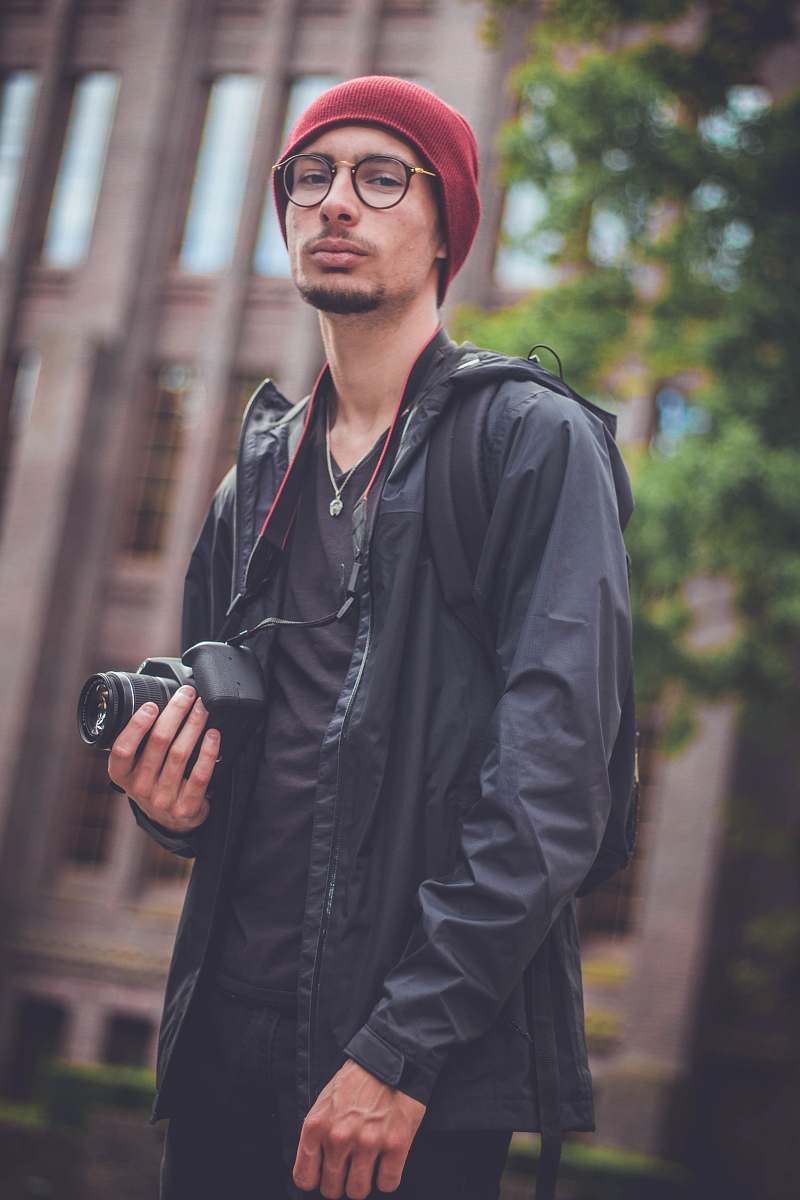 people man holding black DSLR camera person