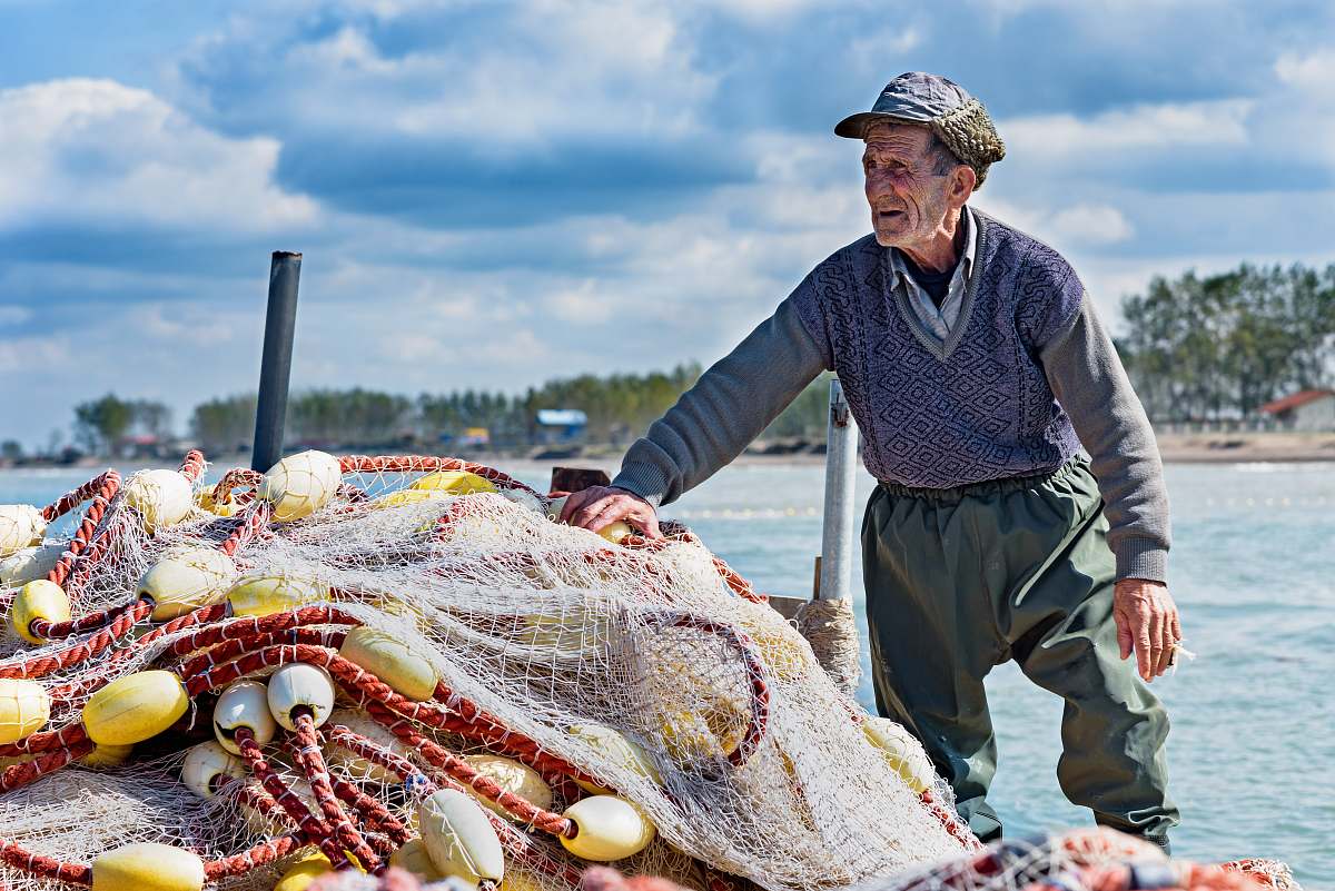 people man holding fishing net person