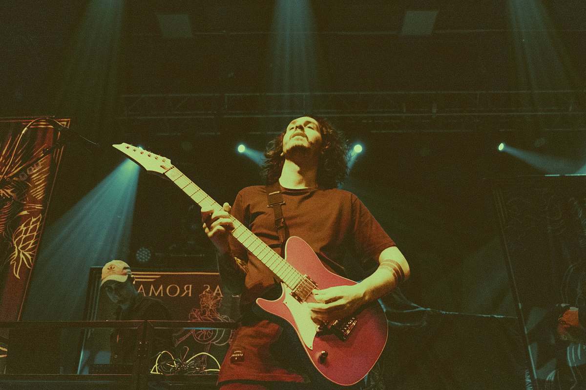 people man holding red electric guitar person