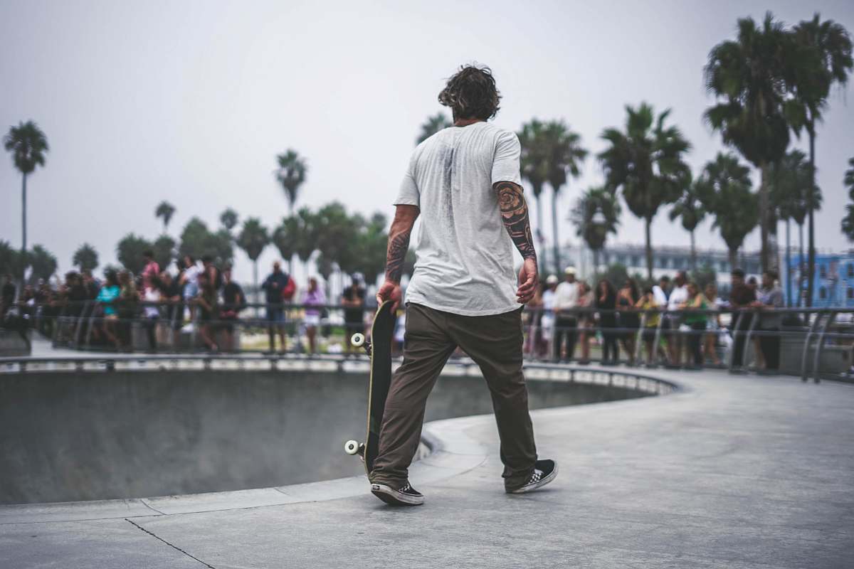 people man holding skateboard in skate park person