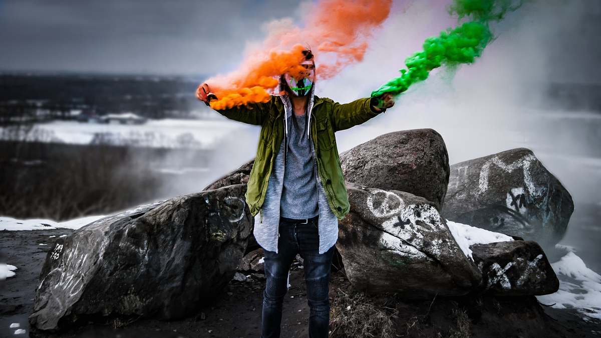 people man holding smoke flares person