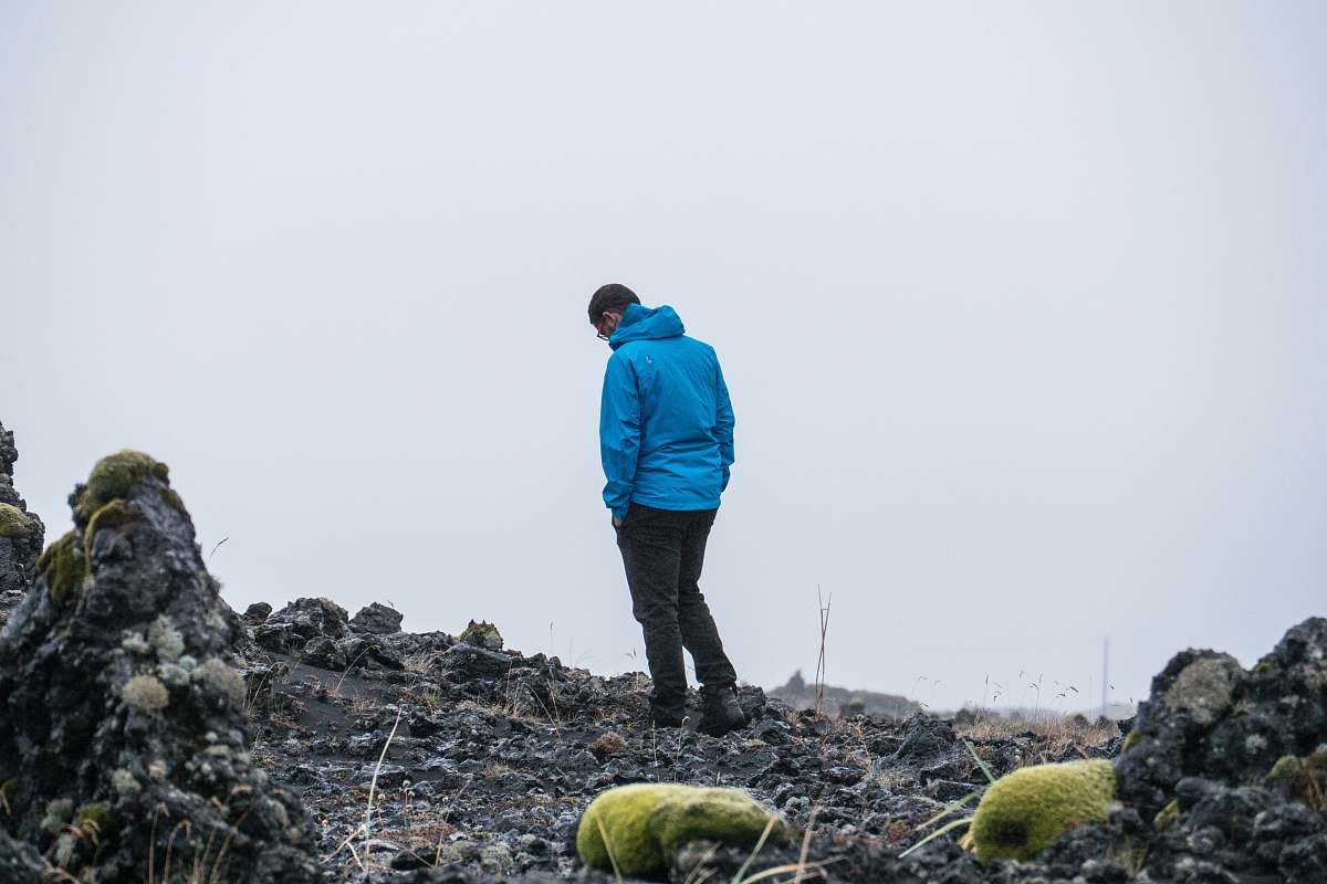people man in blue jacket hands on pocket person